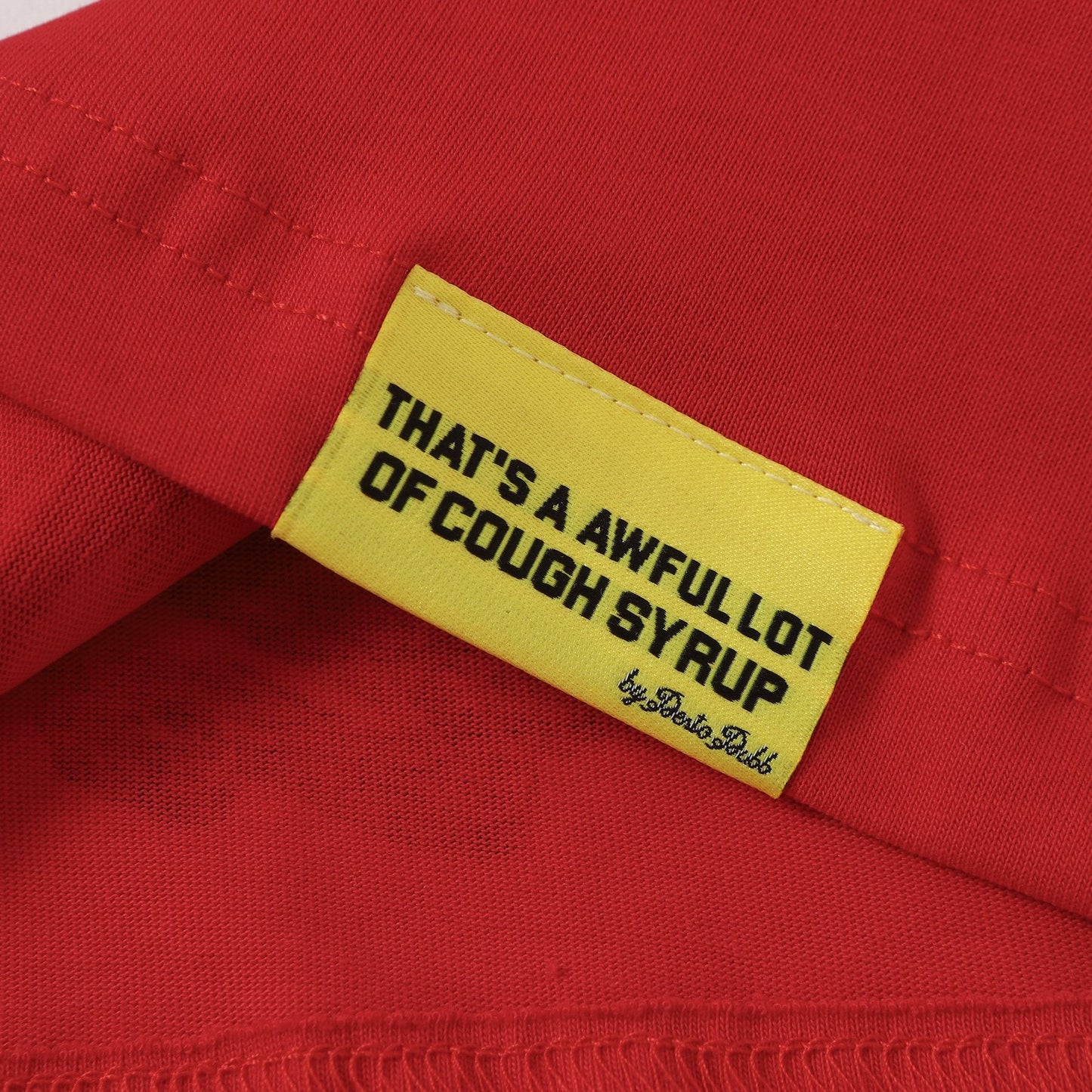 THAT'S A AWFUL LOT OF COUGH SYRUP Bottle Graphic T-Shirt — hang_tag