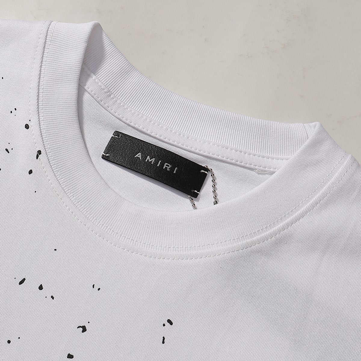 AMIRI Paint Splatter Graphic T-Shirt — neck_label