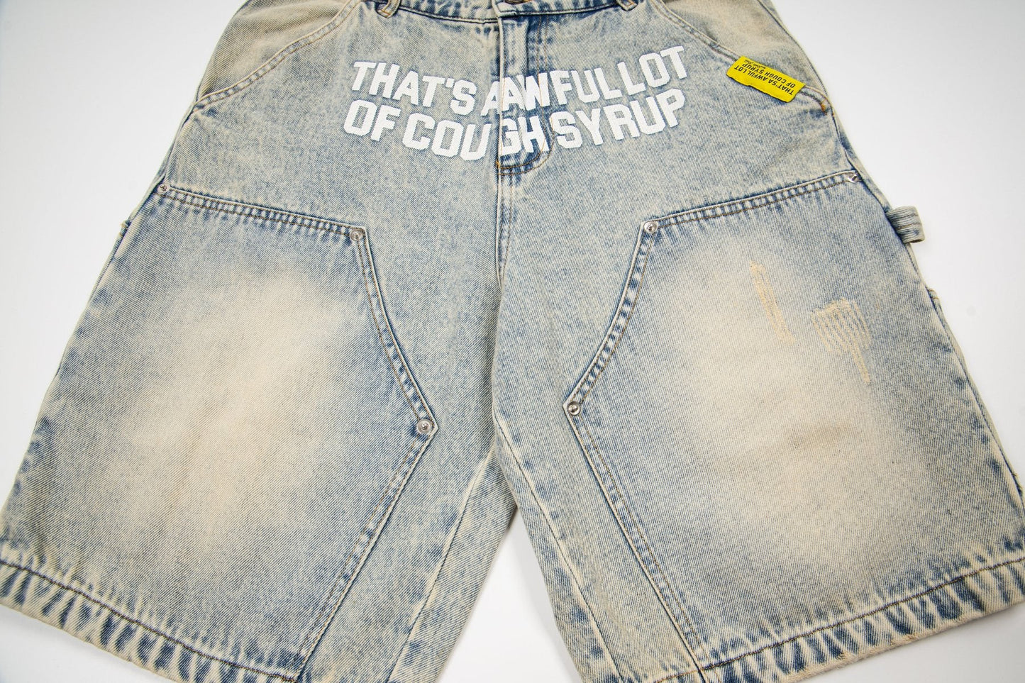 THAT'S A AWFUL LOT OF COUGH SYRUP Washed Denim Graphic Shorts — front