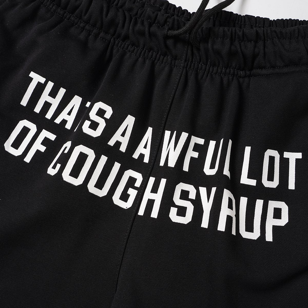 THAT'S A AWFUL LOT OF COUGH SYRUP Black Graphic Shorts — detail