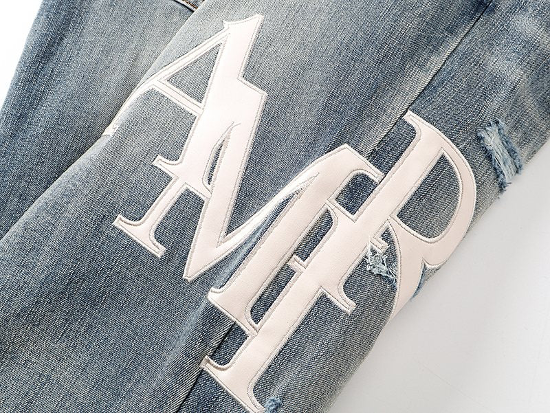 AMIRI Light Blue Distressed Appliqué Jeans — detail